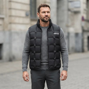 Homme portant la Doudoune sans Manche Chic Homme noir, maille col rond grise et pantalon anthracite
