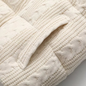 Doudoune sans manche hiver beige en gros plan, poche fendue bordée de maille